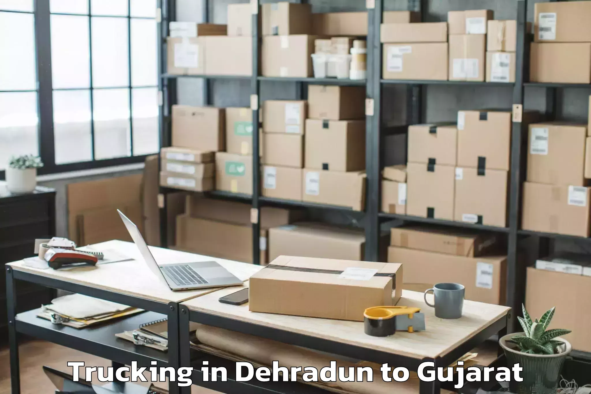 Book Dehradun to Dholka Trucking Online